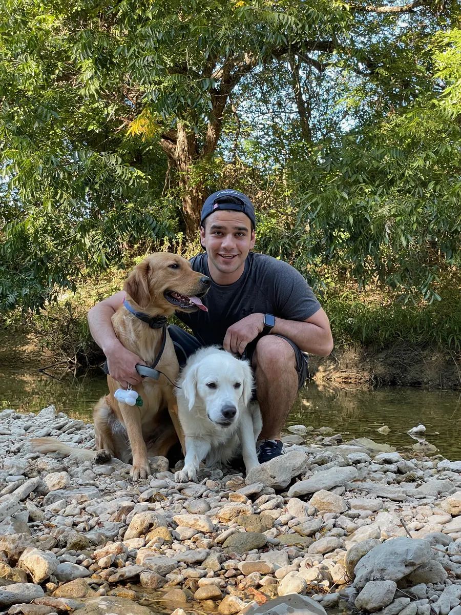 Bill and Shams standing on a wooded trail
